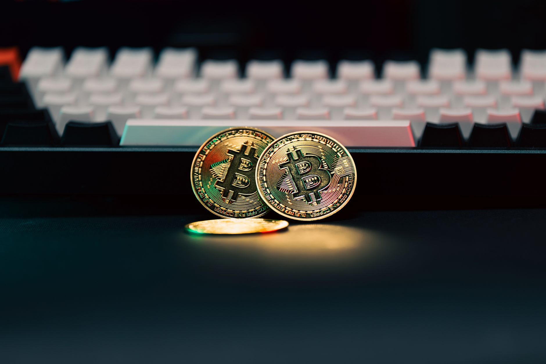 Golden Bitcoin coins in front of a keyboard, symbolizing digital currency and finance — Online Baccarat Lets You Experience R